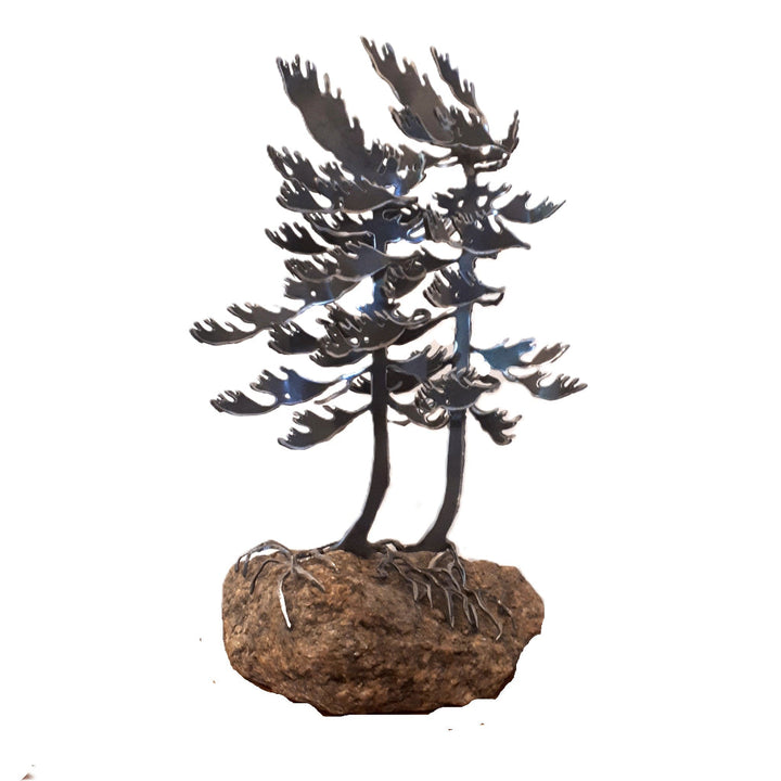 Metal sculpture of two white pine trees on a piece of Canadian granite